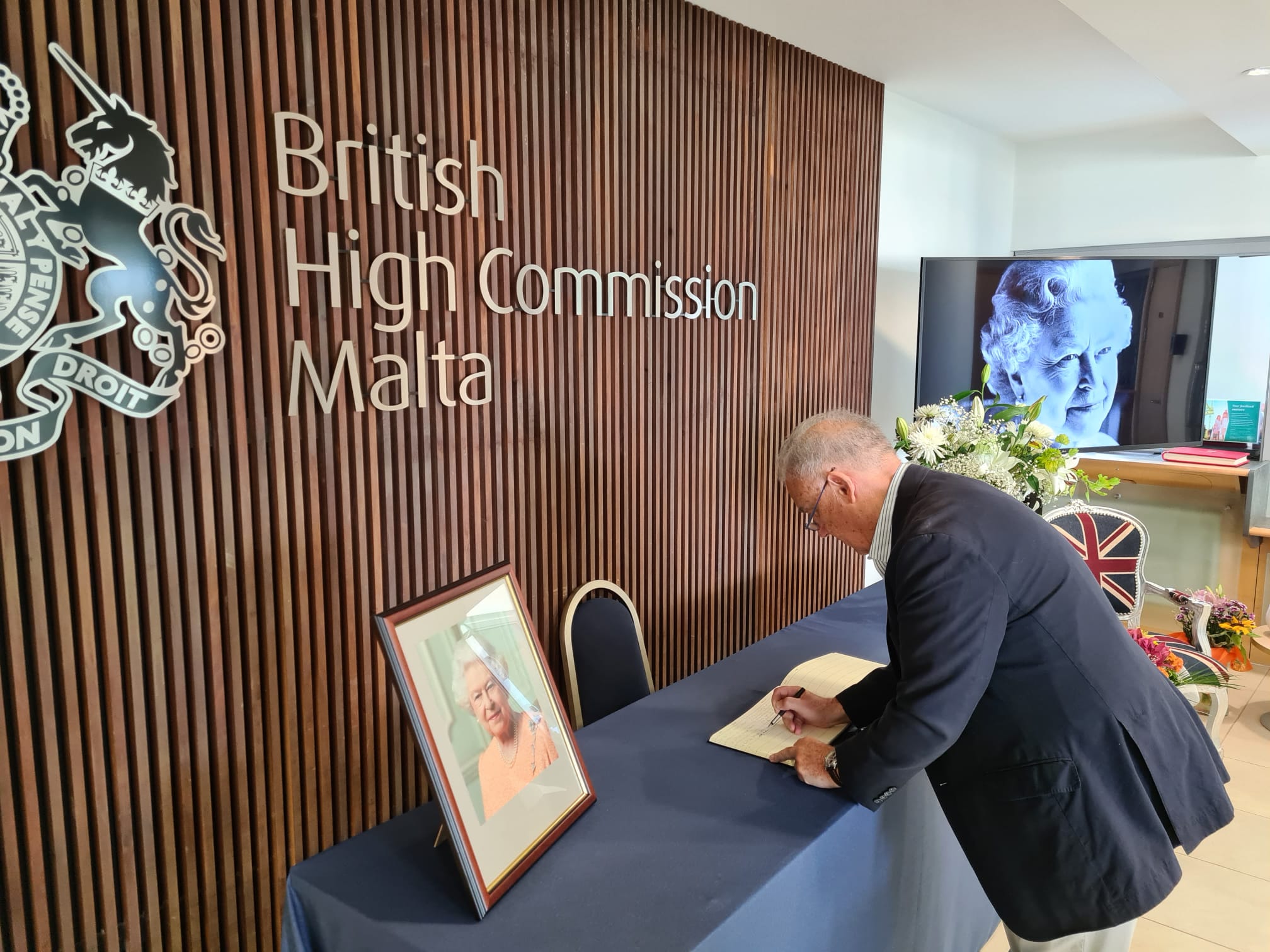 Dr Michael Frendo signs book of condolences at British High Commission